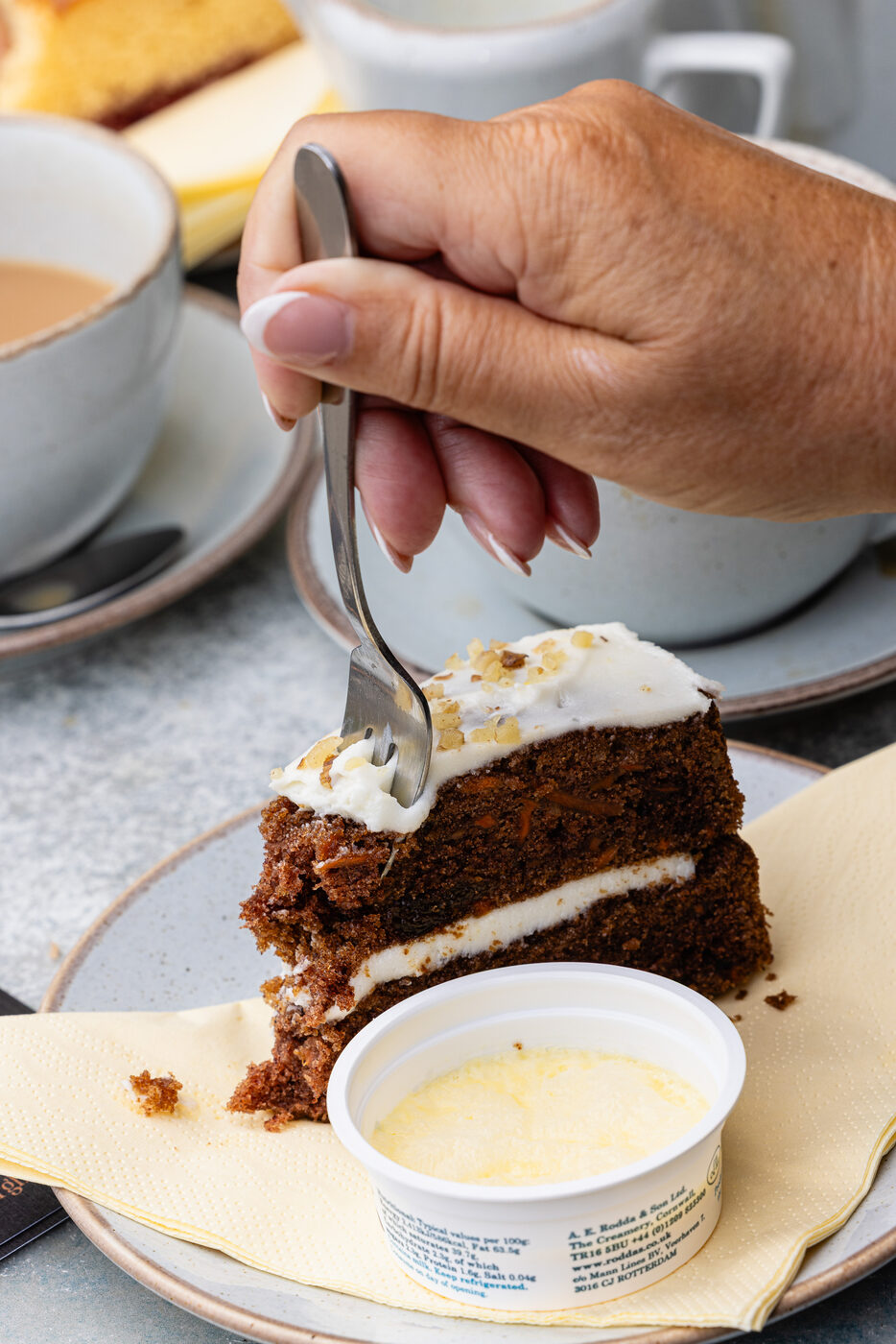 A slice of home-baked carrot cake with clotted cream