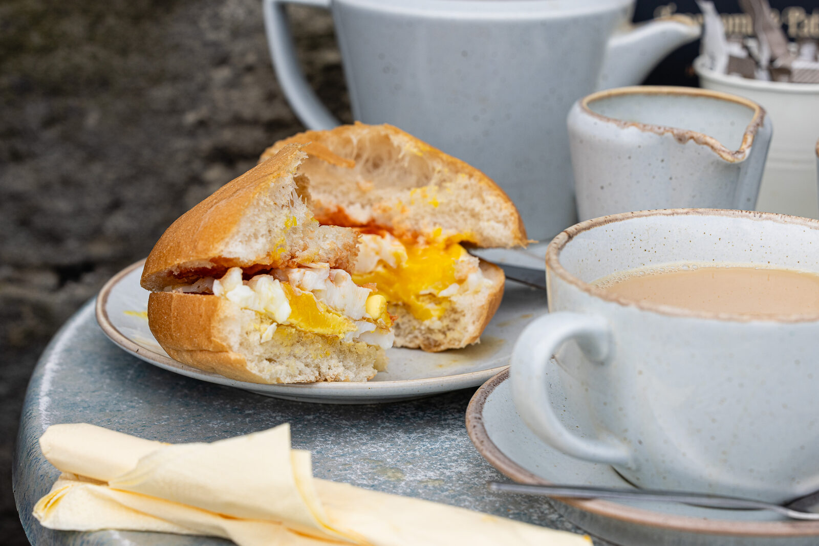 A fried egg roll with a pot of tea in the patio garden