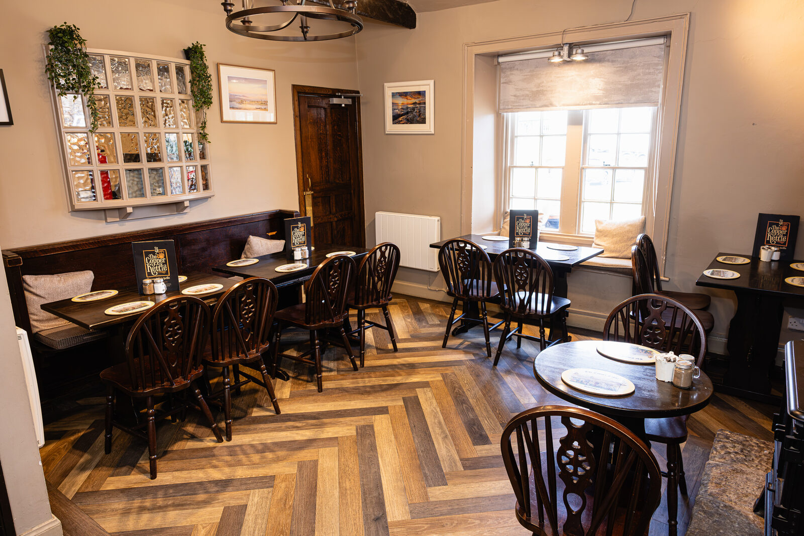 The tearoom interior with oak panelling and coastal artwork