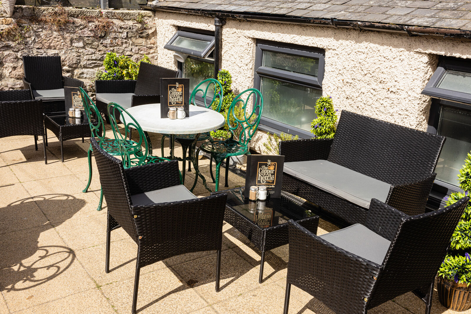 Table and seating in the Copper Kettle patio garden